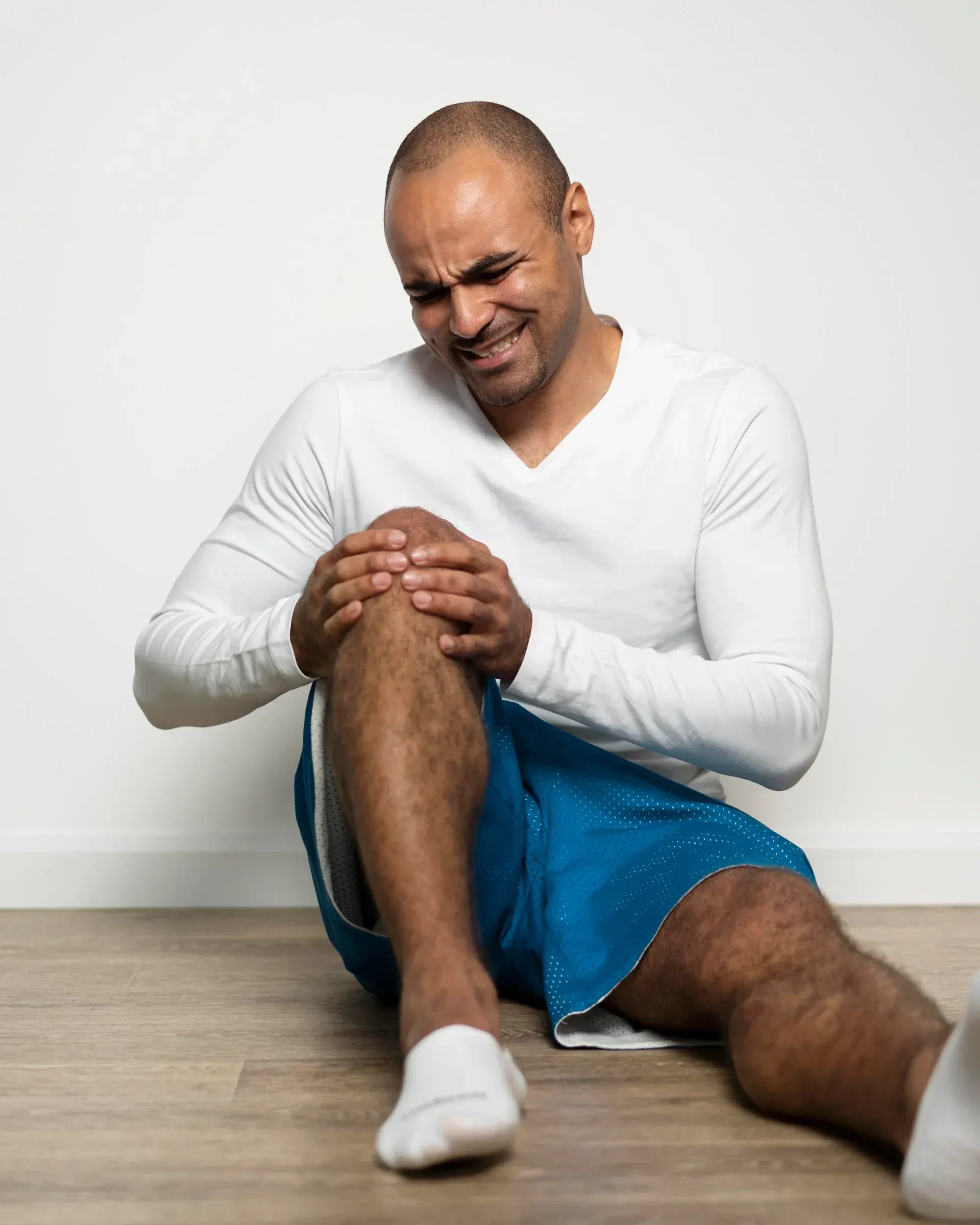 Older adult with knee pain learning about arthritis options in Fort Walton Beach