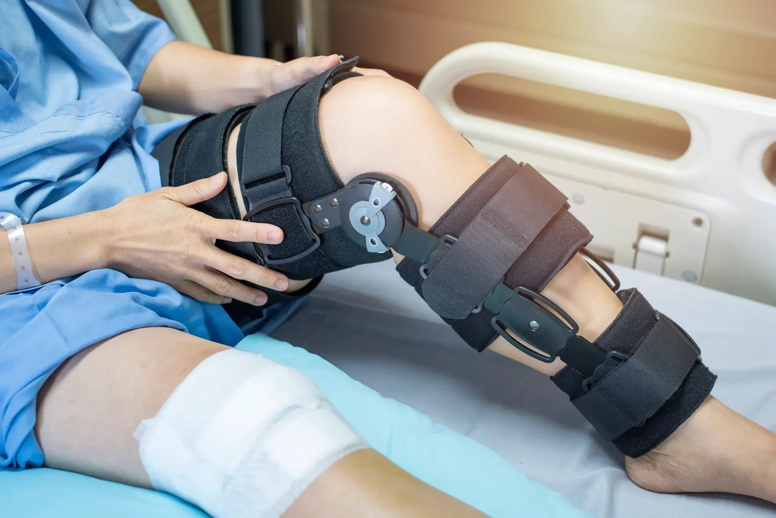 Orthopedic surgeon fitting a hinged knee brace at Emerald Coast Ortho in Fort Walton Beach, FL